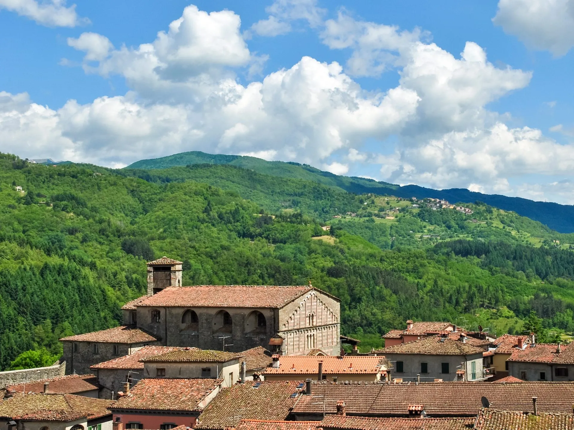 View of Castiglione di Garfagnana, a small town in Tuscany (Italy), with surrounding hills in background