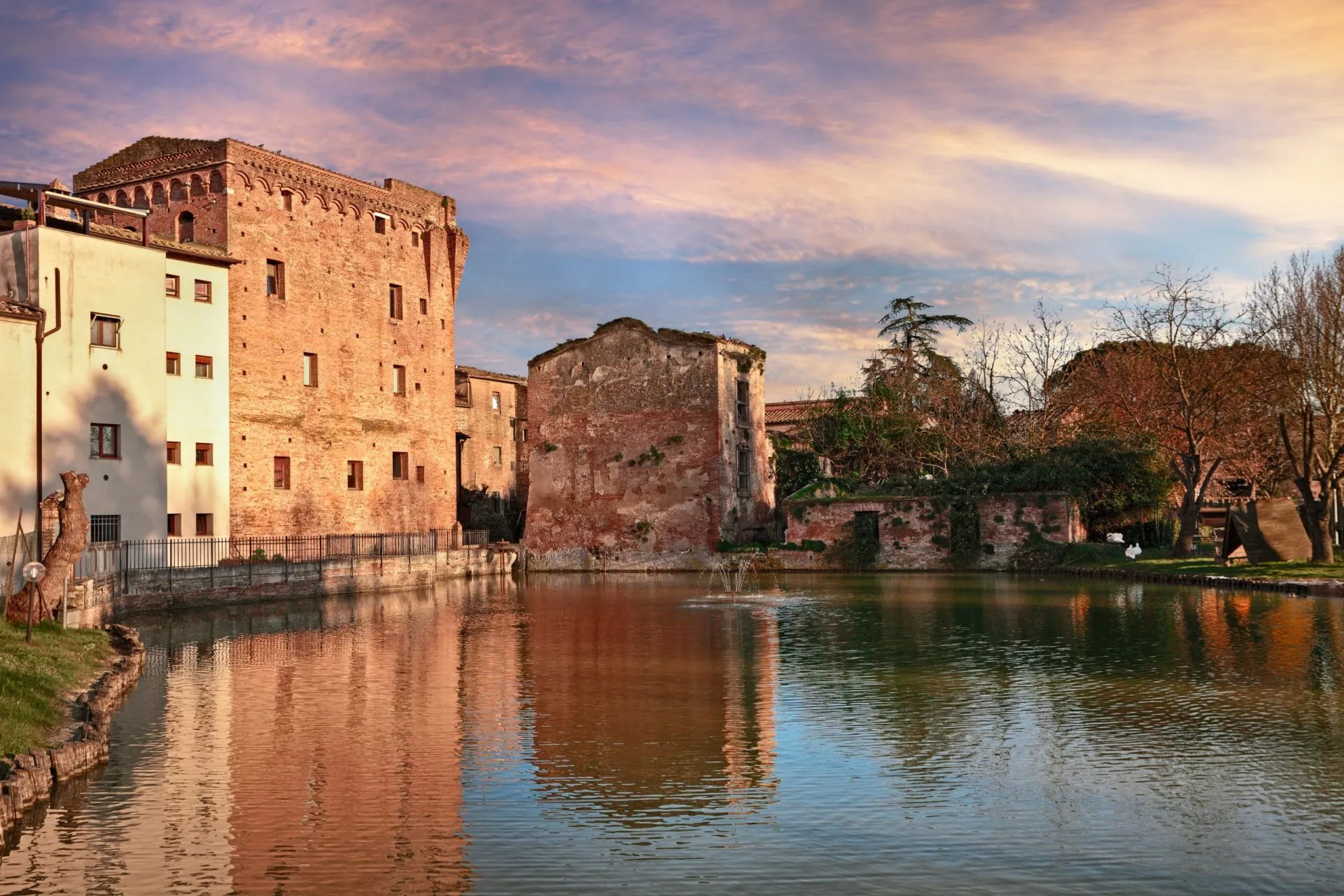 Monteroni d'Arbia, Siena, Tuscany, Italy: view at sunset of the ancient water mill and the pond